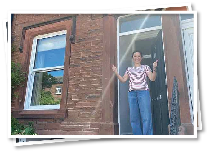 Christel standing outside North View B&B in Penrith on the day the B&B sale was completed, smiling in front of the building