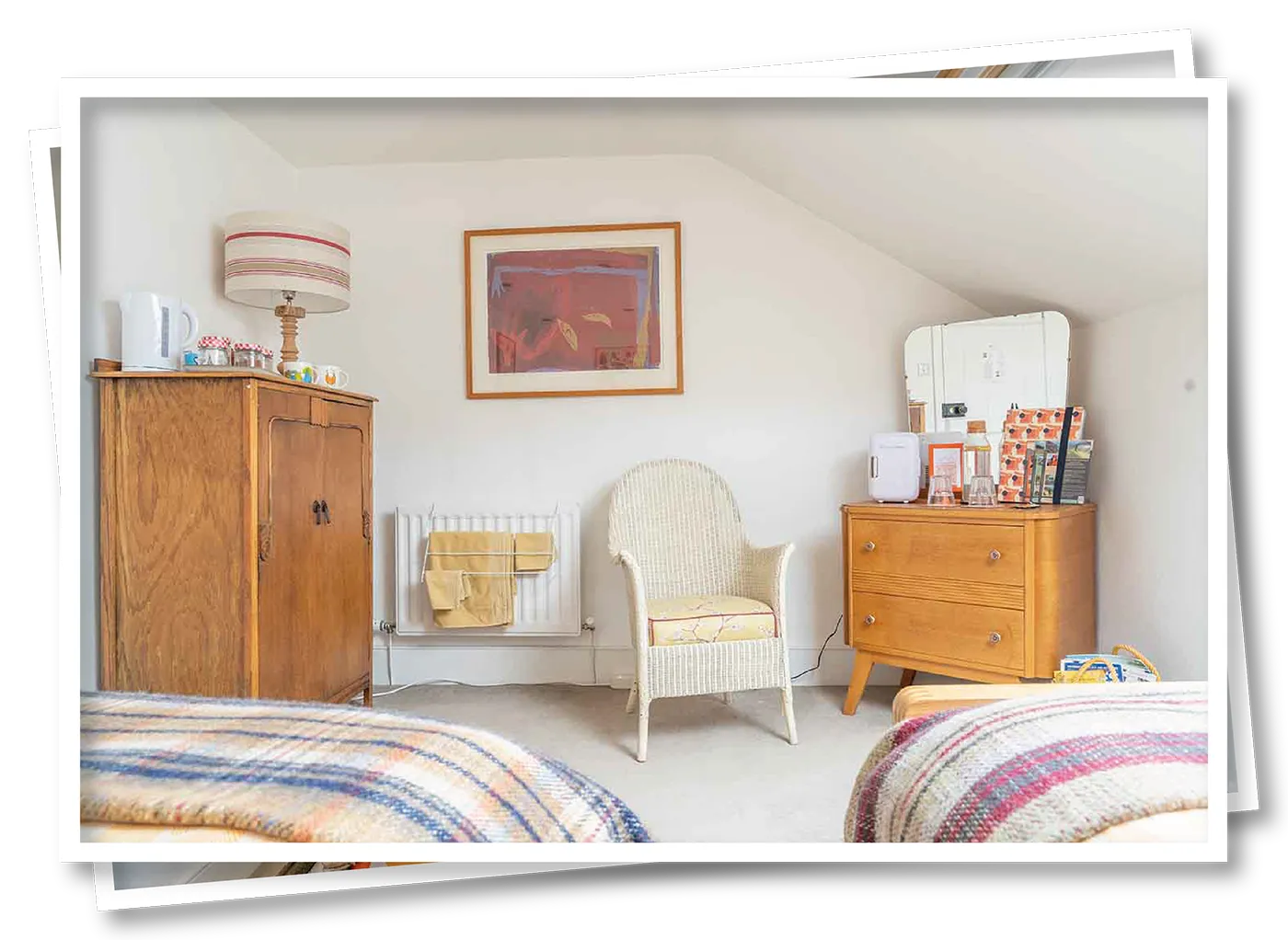 Inside the Orange Herdy Room at North View B&B, showing the beds, dresser, refreshment tray, and a cosy seating area