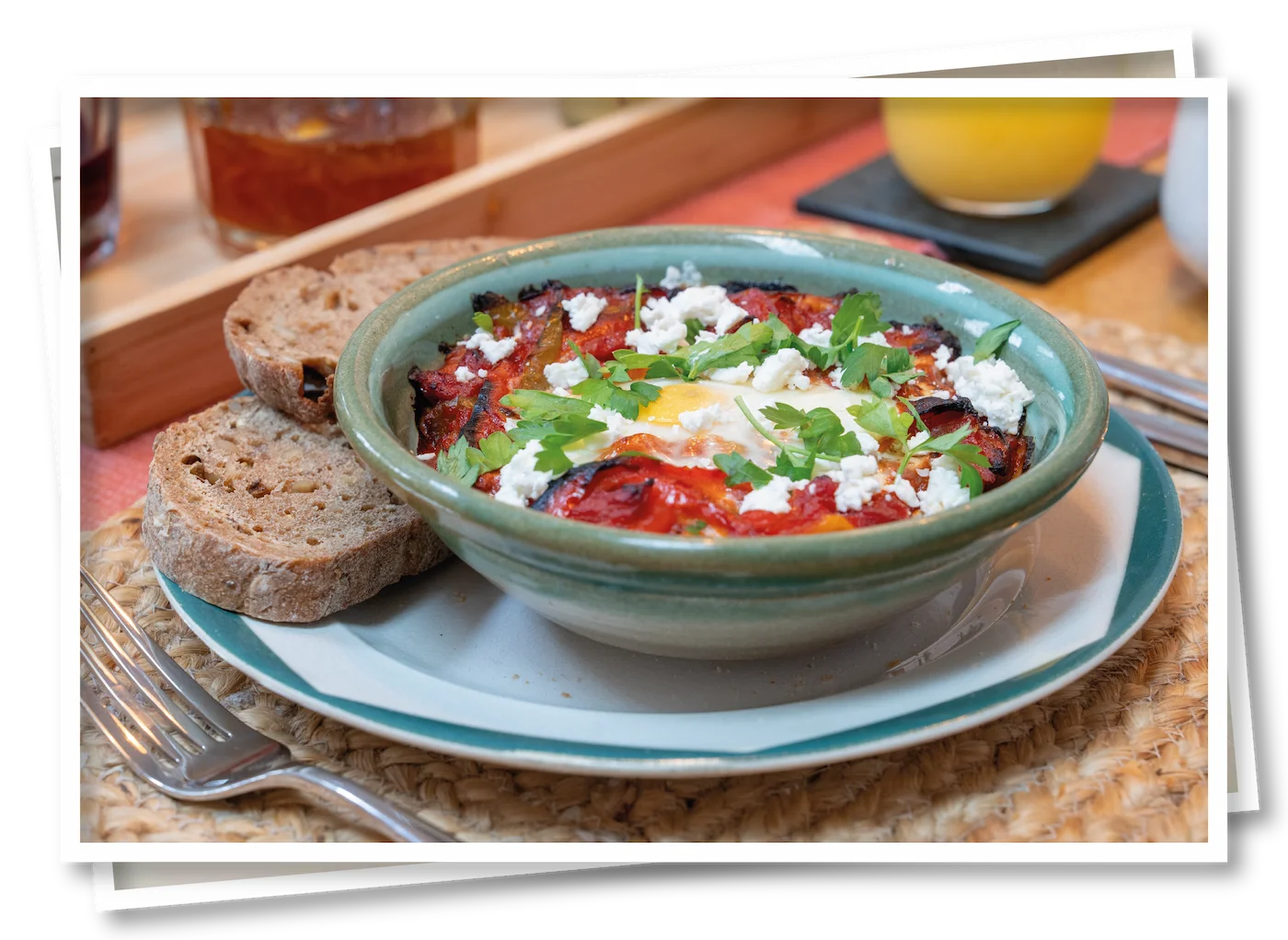 Shakshuka, a cooked breakfast dish of spiced roasted vegetables served with crusty bread.
